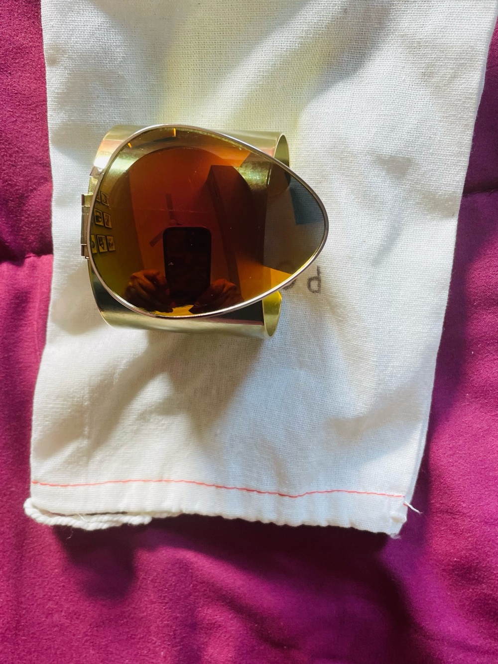 Gold Metal Cuff Bracelet with Amber-Tinted Teardrop sunglass and mirror.